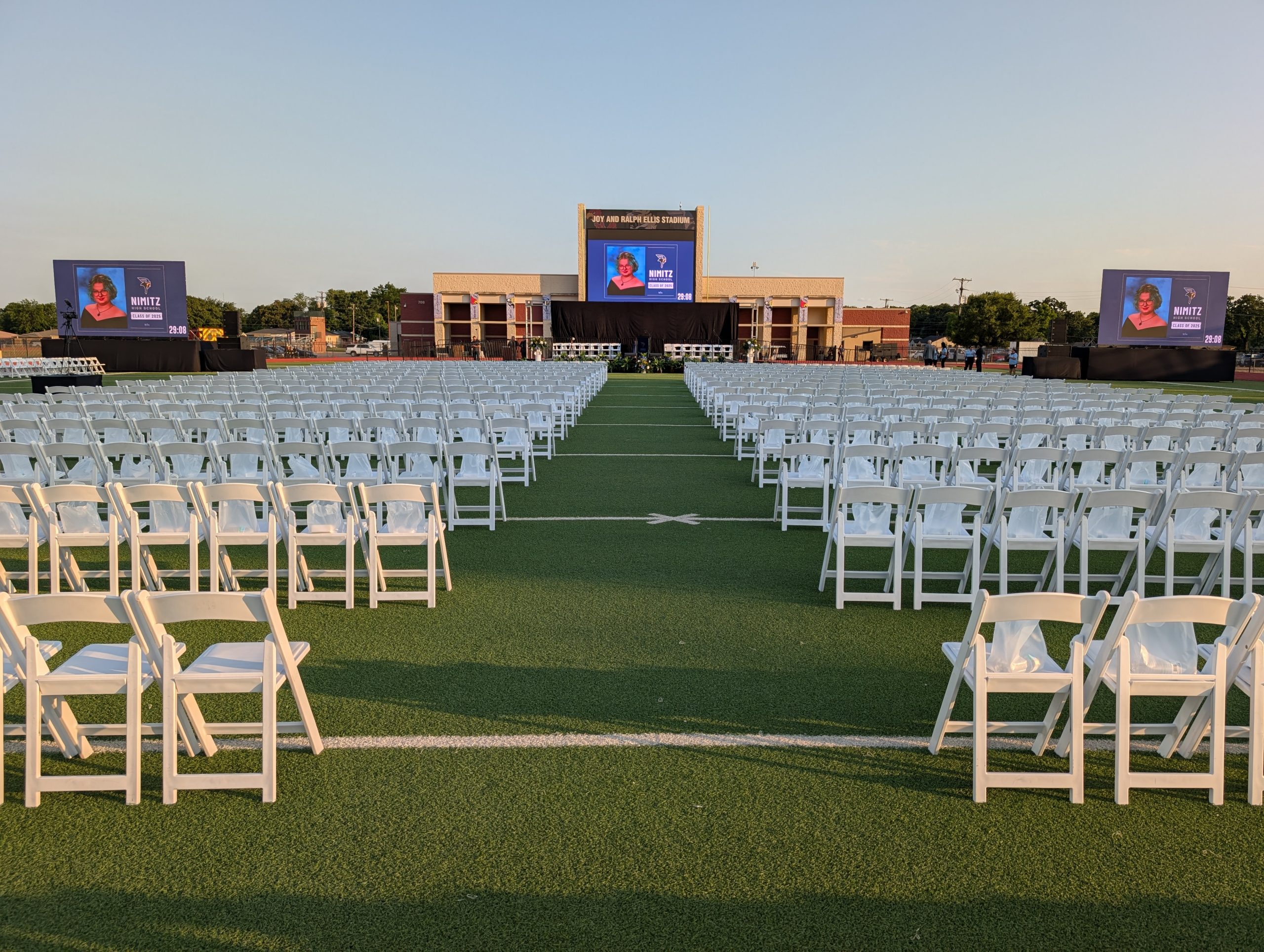 Left, right, and center LED walls with ADA-compliant ramps and railings—stage built in front of a building with care for sensitive surfaces