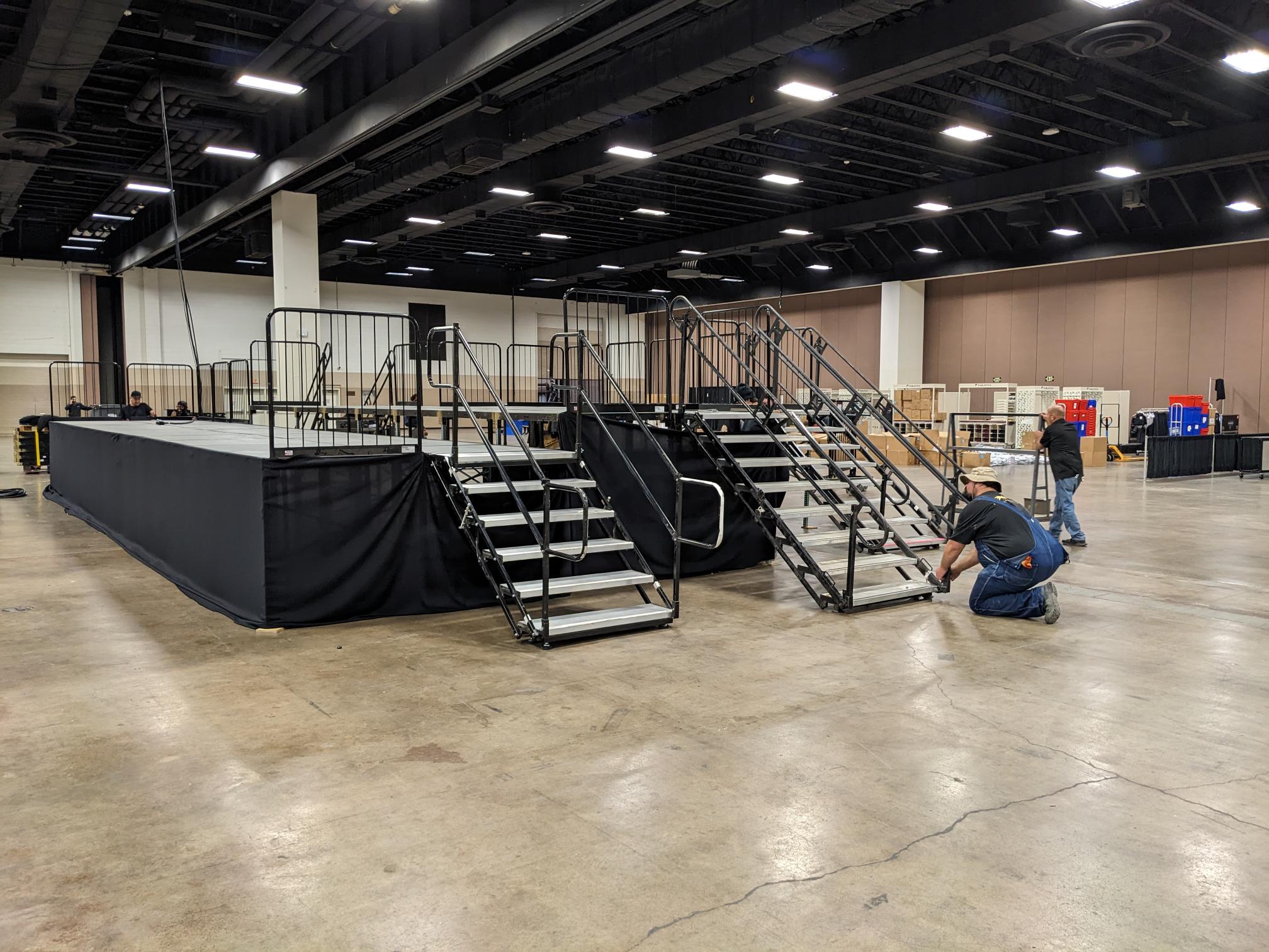 Press risers and multi-level platforms with secure handrails, providing clean lines and safe access for guests and media