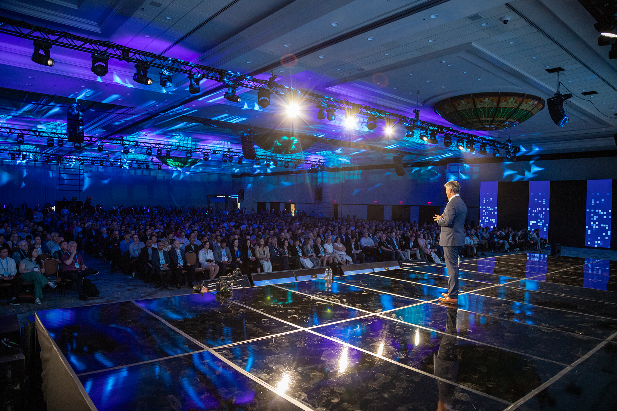 corporate presenter on black gloss marlite stage